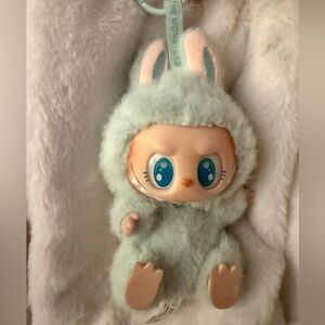This is a Pop Mart Labubu "Have a Seat" vinyl plush doll in mint green